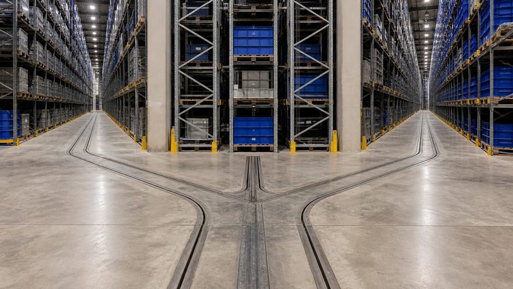 Warehouse floor tracks joining storage aisles to a central hub