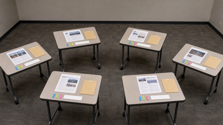 Six evaluator stations with varied page samples and shared rating markers